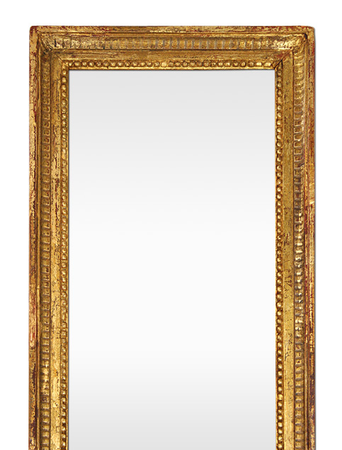 Grand miroir doré patiné décor cannelures style Louis XVI